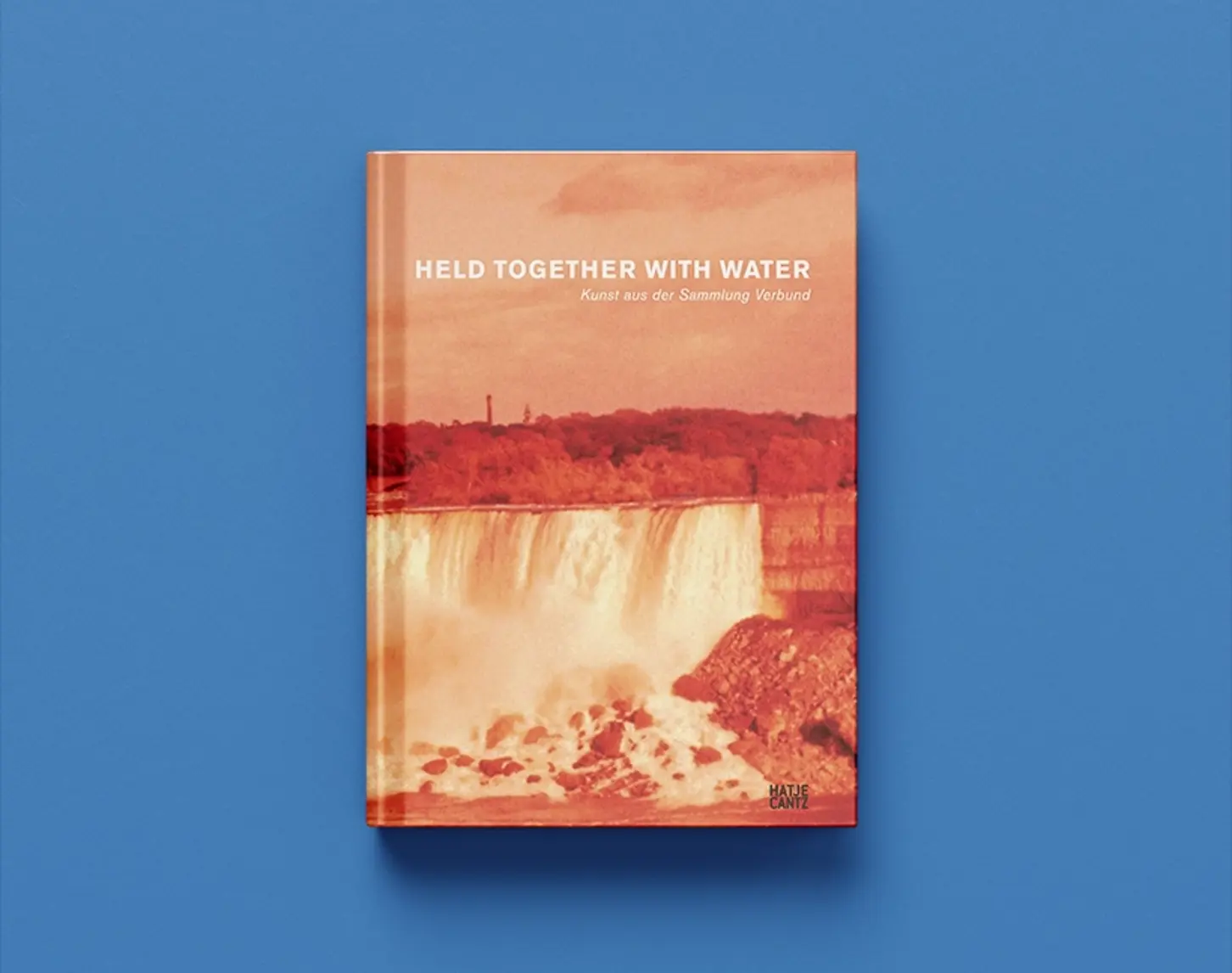 The exhibition catalog Held together with water from 2007 shows a waterfall. The photography is in orange tones.