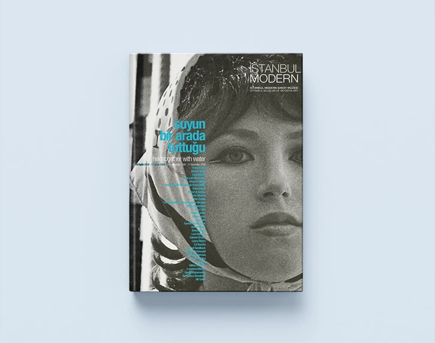 The exhibition catalog Held together with water from 2010 shows a black and white photo of a woman wearing a headscarf. Her bangs peek out from under her headscarf. She looks past the camera.