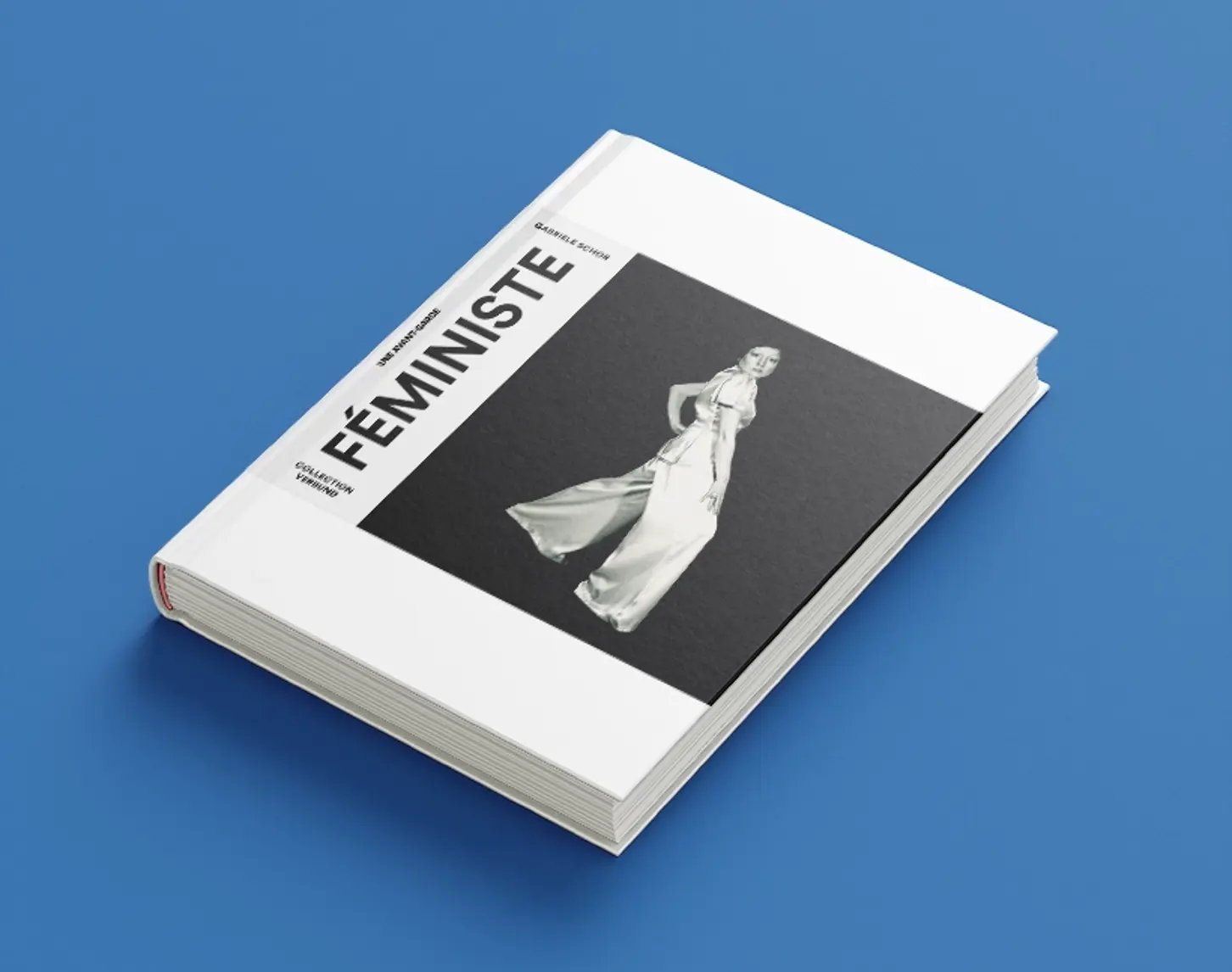 The Féministe exhibition catalog is decorated in black and white tones. In the center is a photograph of an artist against a black background. She herself is wearing white and looking over her shoulder into the camera.